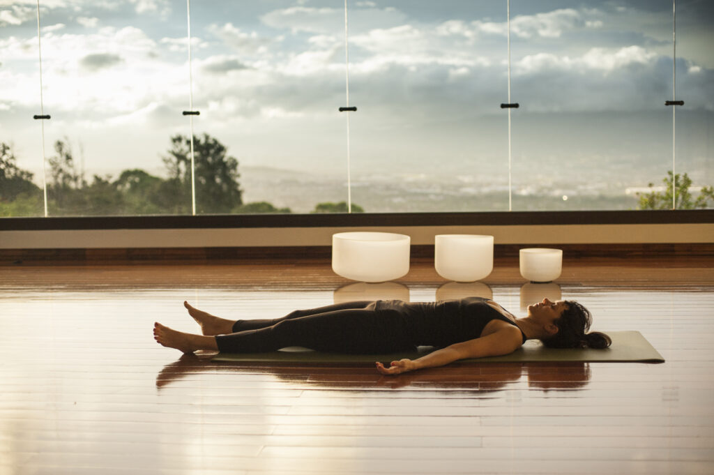 Woman lying savasana over looking the Central Valley of Costa Rica
